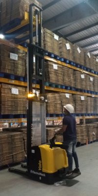 man working with electric stacker
